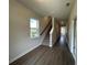 Inviting hallway with wood floors, staircase, and natural light streaming through the window at 5100 Double Eagle, Summerville, SC 29485