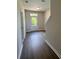 Inviting hallway with wood floors, staircase, and a glass front door at 5100 Double Eagle, Summerville, SC 29485
