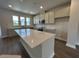 Bright kitchen featuring a large island with quartz countertops, stainless steel appliances, and hardwood floors at 5100 Double Eagle, Summerville, SC 29485