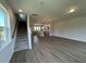 Open floor plan with hardwood floors leading to kitchen and staircase at 5100 Double Eagle, Summerville, SC 29485
