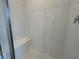 The white tile shower features a built-in bench and a glass door, providing a clean and modern aesthetic at 5100 Double Eagle, Summerville, SC 29485