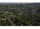An aerial view shows the property's setting amidst trees, a golf course, and the ocean at 5504 Green Dolphin Way, Kiawah Island, SC 29455