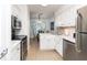 Bright kitchen featuring white cabinetry and stainless steel appliances at 5504 Green Dolphin Way, Kiawah Island, SC 29455