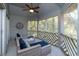 Relax on this screened-in porch with seating and wooded views at 5504 Green Dolphin Way, Kiawah Island, SC 29455