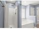 Bathroom features a shower with a white curtain and a soaking tub with a glass block window at 569 Pointe Of Oaks Rd, Summerville, SC 29485