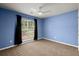A comfortable carpeted bedroom with a ceiling fan and a window that let's in lots of natural light at 569 Pointe Of Oaks Rd, Summerville, SC 29485