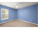 Bedroom features a large window and neutral carpet, complemented by a light blue wall color at 569 Pointe Of Oaks Rd, Summerville, SC 29485