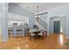 Dining Room featuring hardwood floors, stylish lighting, staircase, and open entryway to kitchen at 569 Pointe Of Oaks Rd, Summerville, SC 29485