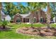 Charming brick home with a well-manicured lawn and mature palm trees in a desirable neighborhood at 569 Pointe Of Oaks Rd, Summerville, SC 29485