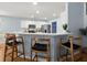 Stylish kitchen with a breakfast bar, white cabinets, and stainless steel appliances at 569 Pointe Of Oaks Rd, Summerville, SC 29485