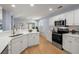 Bright kitchen featuring white cabinets, granite countertops, and stainless steel appliances at 569 Pointe Of Oaks Rd, Summerville, SC 29485