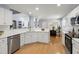 Open kitchen with white cabinets, modern appliances, breakfast bar, and seamless views to dining area at 569 Pointe Of Oaks Rd, Summerville, SC 29485