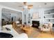 Bright living room featuring a fireplace, built-in shelves, and an open floor plan with hardwood floors at 569 Pointe Of Oaks Rd, Summerville, SC 29485