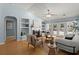Bright living room features fireplace, built-ins, stylish furnishings and pool views from the French doors at 569 Pointe Of Oaks Rd, Summerville, SC 29485