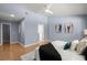 Spacious main bedroom with a vaulted ceiling, wood floors, stylish decor, and a walk-in closet at 569 Pointe Of Oaks Rd, Summerville, SC 29485