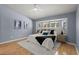 Light-filled main bedroom with a tray ceiling, large windows, stylish decor, and neutral-toned color scheme at 569 Pointe Of Oaks Rd, Summerville, SC 29485