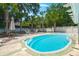 A lush backyard featuring a sparkling pool, a cozy firepit, and outdoor seating for relaxation and entertaining at 569 Pointe Of Oaks Rd, Summerville, SC 29485