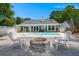 Backyard with a pristine pool and a well-manicured patio with a cozy firepit and outdoor seating at 569 Pointe Of Oaks Rd, Summerville, SC 29485