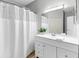 Bathroom features white vanity, large mirror, and shower with white shower curtain at 60 Fenwick Hall Aly # 415, Johns Island, SC 29455