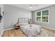 Bright bedroom features wood-look flooring, neutral walls, ceiling fan, and natural light from the large window at 60 Fenwick Hall Aly # 415, Johns Island, SC 29455