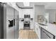 Bright kitchen with white cabinetry, stainless steel appliances, and a skylight at 60 Fenwick Hall Aly # 415, Johns Island, SC 29455