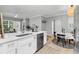 Open concept kitchen featuring a stainless steel dishwasher, table, and chairs at 60 Fenwick Hall Aly # 415, Johns Island, SC 29455