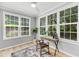 Bright office with large windows, wood floors, and a stylish desk setup at 60 Fenwick Hall Aly # 415, Johns Island, SC 29455
