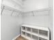 Walk-in closet features wood-look floors, white walls, and built-in white shelving at 60 Fenwick Hall Aly # 415, Johns Island, SC 29455