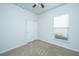 Bedroom with neutral carpet, ceiling fan, window and double door closet at 626 Battery Edge Dr, Summerville, SC 29486