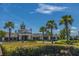 Community clubhouse exterior featuring an American flag and palm trees at 626 Battery Edge Dr, Summerville, SC 29486