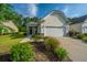 Charming one-story home with a two-car garage, well-manicured lawn and shrubbery at 626 Battery Edge Dr, Summerville, SC 29486