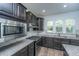 Stylish kitchen featuring stainless steel appliances, granite counters and dark wood cabinets at 626 Battery Edge Dr, Summerville, SC 29486