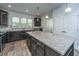 Well-lit kitchen features stainless steel appliances, granite counters, and center island at 626 Battery Edge Dr, Summerville, SC 29486