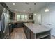 Spacious kitchen with granite island, stainless appliances, modern lighting, and dark cabinetry at 626 Battery Edge Dr, Summerville, SC 29486