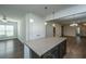 Open kitchen with granite island, modern lighting, hardwood floors, and stainless steel appliances at 626 Battery Edge Dr, Summerville, SC 29486