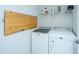 Modern laundry room with washer, dryer, folding table, and shelving at 626 Battery Edge Dr, Summerville, SC 29486