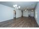 Large living room features a ceiling fan, wood flooring and modern chandelier at 626 Battery Edge Dr, Summerville, SC 29486