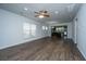 Spacious living room with a ceiling fan and wood flooring flowing into kitchen at 626 Battery Edge Dr, Summerville, SC 29486