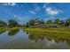 Pond view with the community entrance tower, manicured lawns and landscaping at 626 Battery Edge Dr, Summerville, SC 29486