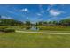 Picturesque pond with the community's architectural tower and manicured landscaping at 626 Battery Edge Dr, Summerville, SC 29486