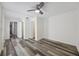 Spacious bedroom featuring closet, wood-look flooring, white walls and trim, and ceiling fan at 634 Rutledge Ave, Charleston, SC 29403