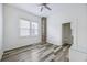 Well-lit bedroom with a ceiling fan, two windows, exposed brick, and a closet with shelving at 634 Rutledge Ave, Charleston, SC 29403
