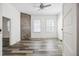 Bright bedroom with modern floors, a brick accent wall, and a ceiling fan at 634 Rutledge Ave, Charleston, SC 29403