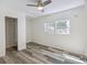 Bedroom with two windows, wood-look flooring, white walls and trim, and ceiling fan at 634 Rutledge Ave, Charleston, SC 29403