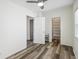 Bedroom with two closets with shelves, wood-look flooring, white walls and trim, and ceiling fan at 634 Rutledge Ave, Charleston, SC 29403
