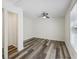 Bedroom with closet, wood-look flooring, white walls and trim, ceiling fan, and large window at 634 Rutledge Ave, Charleston, SC 29403