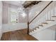 Entryway with hardwood floors, a staircase with a wooden handrail, and large windows for natural light at 634 Rutledge Ave, Charleston, SC 29403