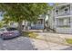 Charming home with a covered front porch, complemented by mature trees and a paved driveway at 634 Rutledge Ave, Charleston, SC 29403