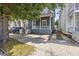 Charming home with a covered front porch, complemented by mature trees and a paved driveway at 634 Rutledge Ave, Charleston, SC 29403