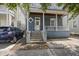 Charming two-story home with blue siding, a cozy front porch, and inviting brick steps at 634 Rutledge Ave, Charleston, SC 29403